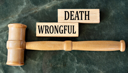 WRONGFUL DEATH - words on wooden blocks on a green background with a judge's gavel