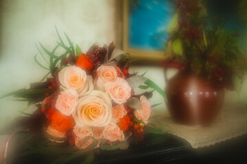 Soft-focus bouquet of peach roses with red accents