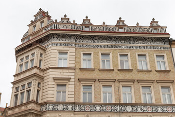 Obraz premium A sizeable and impressive building featuring numerous windows along its facade, elegantly topped with a captivating red roof, stands proudly