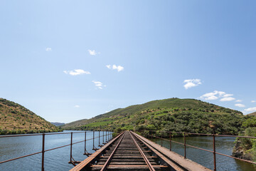Obraz premium Between hills and mountains the Douro river and the small Côa river on a cloudy day in the Côa valley in Portugal