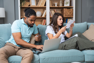 Home finance issues. Young couple having problem with utility bills, high prices and expenses,...
