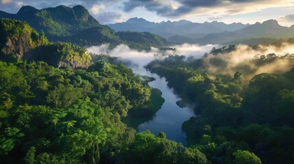 Obraz premium A fog-covered valley with a river snaking through it at dawn