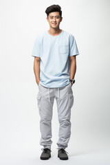 Naklejka premium Smiling man in a light blue color casual outfit standing in a studio