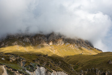 the top of the mountain is shrouded in a thick cloud