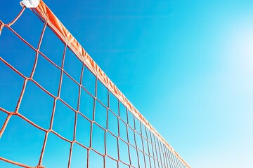 Volleyball net against blue sky. Perfect for a sports or leisure-themed design.