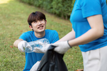 Young Volunteers Collecting Litter in Park, Promoting Environmental Awareness and Community Service