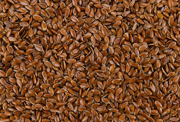 Background of brown flax seeds. Top view. Completely in focus.