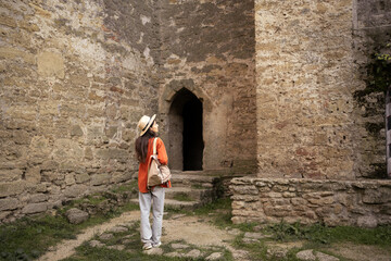 woman traveler. tourist walking in ancient fortress looking at old city sights