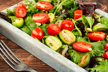 Fresh lettuce leaves and tomato salad.