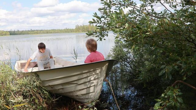 Children, playing on a boat in a river, summertime, watching nature with binoculars, sunny weather