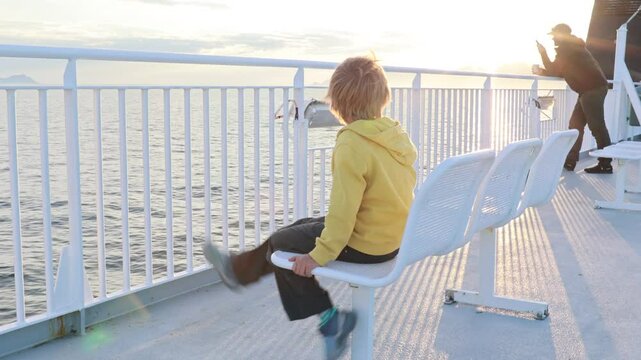 People, enjoying ferry ride between Bodo and Lofoten Moskenesoya summertime, child and adults on a ferry