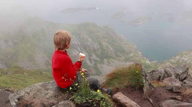 Children and adults, happy family with dog, climbing Festvagtinden via Heiavatnet trail in Norway