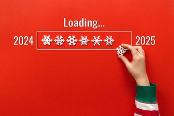 loading New Year. hand puts snowflake on red background. holiday banner