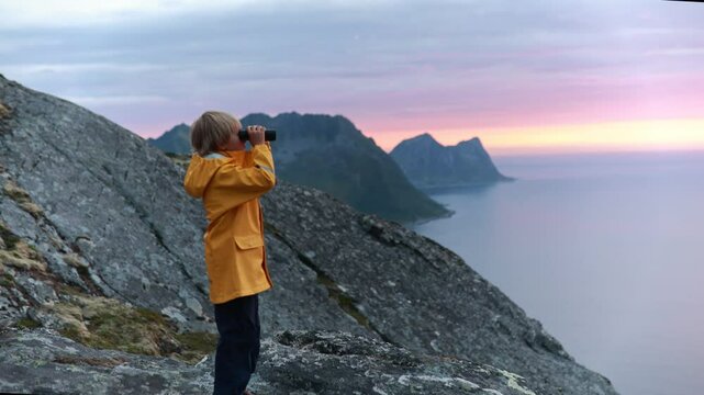 Children and adults, family with dog, hiking Grytetippen trail in Senja, Lofoten on a sunny summer day