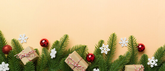 Christmas decorations and fir tree branch and gift boxon dark table. Top view frame with copy space