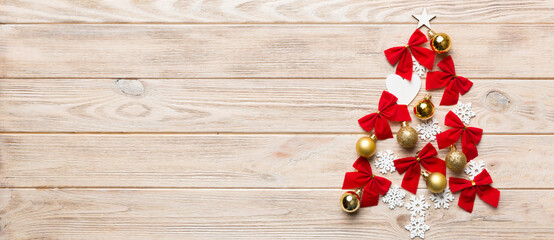 Christmas tree made from colored ball decoration on colored background, view from above. New Year minimal concept with copy space