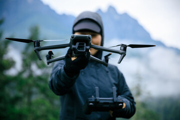 People hold a drone in summer forest