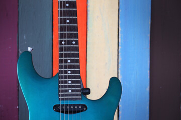 Obraz premium Vibrant Guitar Against Colorful Wooden Background
