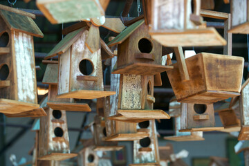 Wooden Birdhouses Hanging in a Bright Display