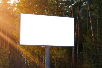 Advertising billboard along the road in the city on a sunny day. Background for design. 