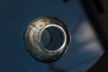 Old dirty glass round jar floating in water. Outdoor dishwashing.