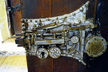Fototapeta premium The famous medieval mechanism with 19 locks on the door to the sacristy of the fortified church of Biertan (Transylvania, Romania), a UNESCO World Heritage Site. Interior landmark: 1515 door lock