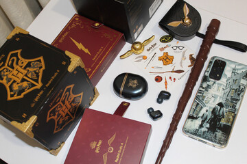 Fototapeta premium Kyiv, Ukraine. 10.10.2024:A magical collection of Harry Potter-themed merchandise featuring wands, gadgets, and collectibles displayed on a table. Stock editorial photo.