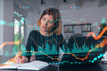 Businesswoman analyzing financial data with charts and graphs in a modern office environment.