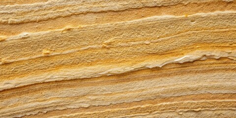 A close-up view of a sandstone formation, revealing the layered structure and earthy tones