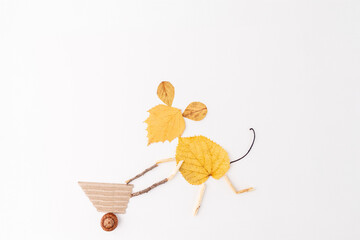 Mouse made of yellow autumn leaves pushing a wheelbarrow with berries, Step in creative process,...