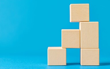 Minimalistic SEO concept with wooden blocks stacked against a blue background, representing online search optimization in a clear and simple style