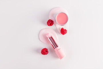 Cosmetic balm in a tube and round jar with a delicate structure on a pink background for lip care. A unique berry complex. Pleasant raspberry aroma.