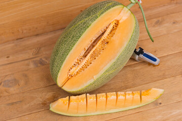 split the orange melon on wood plate