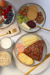 Assortment of various breakfast foods and drinks on the white table. Flat lay.