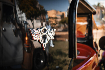Detail of an old vehicle indicating an 8 cylinder internal combustion engine configuration, known as a V8