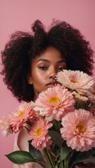 Naklejka premium Close-up portrait of woman holding pink flowers, curly hair, neutral expression