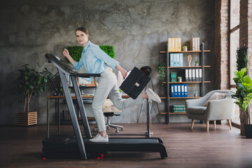 Photo of cheerful positive lady recruiter dressed shirt holding office bag running treadmill...