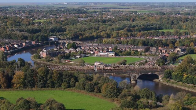 Aerial view of River Ribble going through Preston in the United Kingdom with viaduct and bridge going across