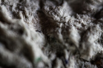 Extreme close up of old gray handmade paper clay with a structure and rough texture. Paper recycling. Selective focus, shallow depth of field.