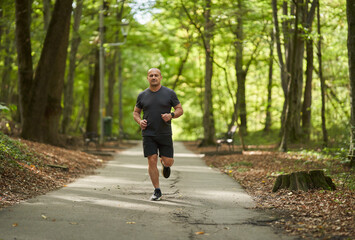 Fototapeta premium Athletic man running in park