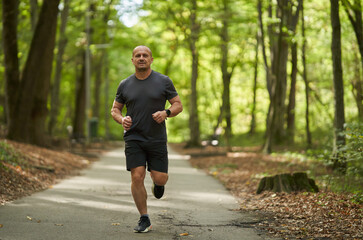 Athletic man running in park