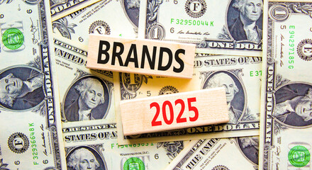 Planning brands 2025 new year symbol. Concept words Brands 2025 on beautiful wooden blocks. Dollar bills. Beautiful background from dollar bills. Business brands 2025 new year concept. Copy space.