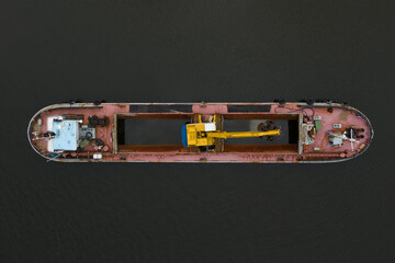 excavator on a barge standing at anchor, top view from the drone