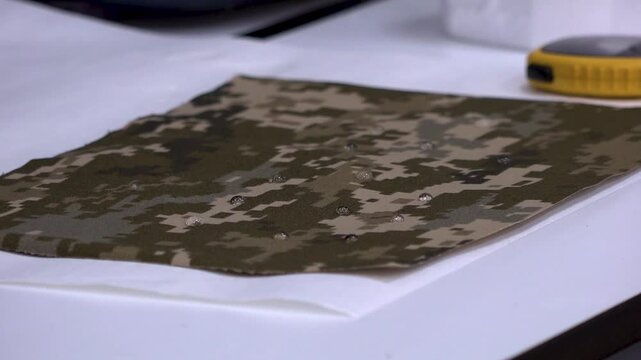 Waterproof test of a fabric in a textile factory or a research and development lab in close up view.