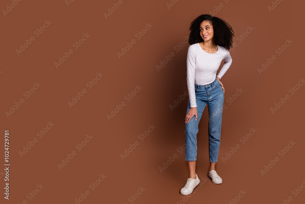 Wall mural Full body portrait of nice young woman look empty space wear pullover isolated on brown color background