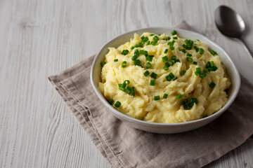 Homemade Chive and Garlic Mashed Potatoes in a Bowl, side view. Copy space.