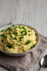 Homemade Chive and Garlic Mashed Potatoes in a Bowl, side view.