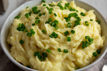 Homemade Chive and Garlic Mashed Potatoes in a Bowl, side view. Close-up.