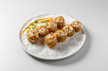 Sushi hosomaki stir-fry with salmon, spicy mayonnaise, toasted almond flakes and teriyaki, isolated on white background