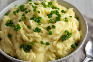 Homemade Chive and Garlic Mashed Potatoes in a Bowl, side view. Close-up.